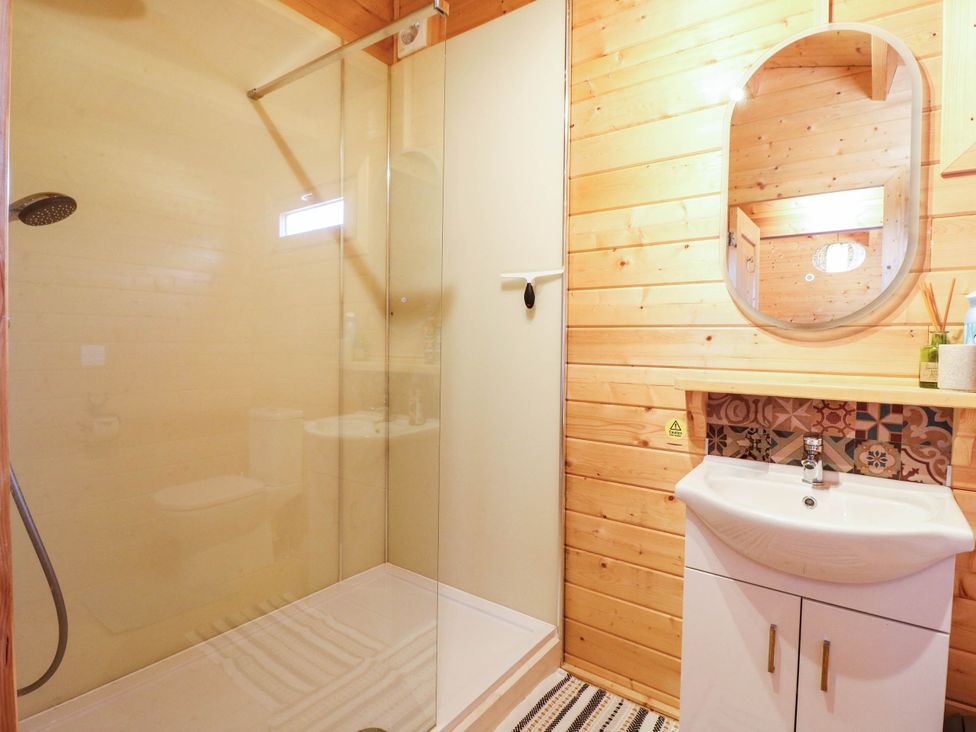 A bathroom with a shower and sink at Willow Lodge in Stowmarket