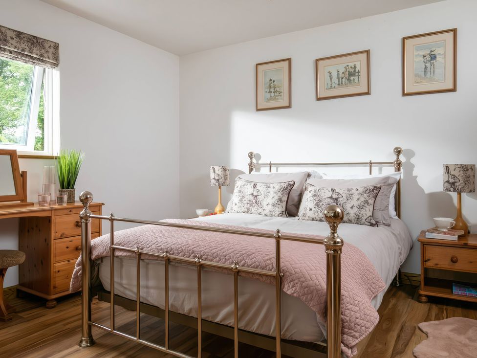 A bedroom with a bed and dresser at Willow Cottage in Constantine