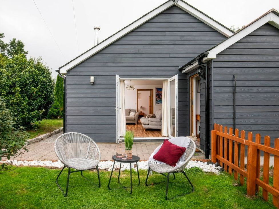 An outdoor seating area with chairs and a table at Willow Cottage in Constantine