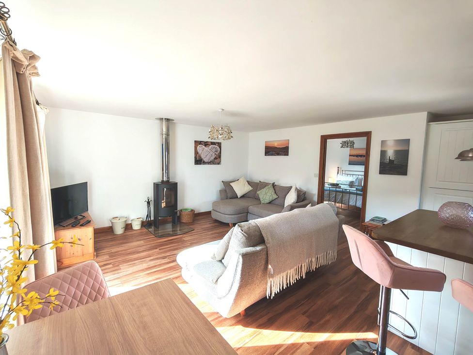 A living room with a sofa and television at Willow Lodge in Constantine