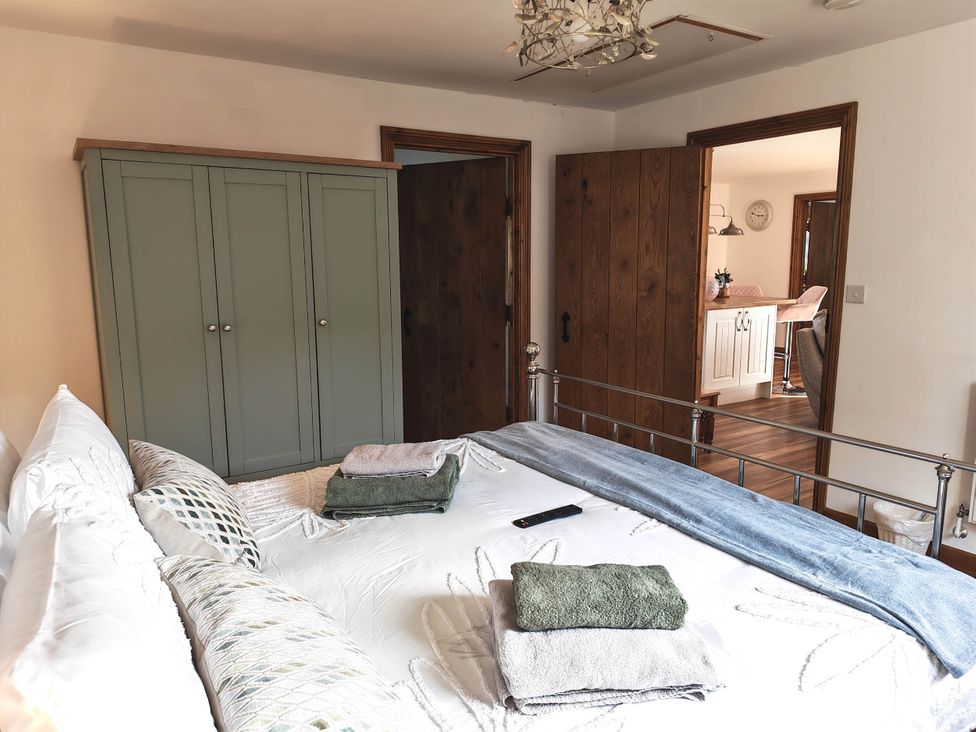 A bedroom with a bed and wardrobe at Willow Lodge in Constantine