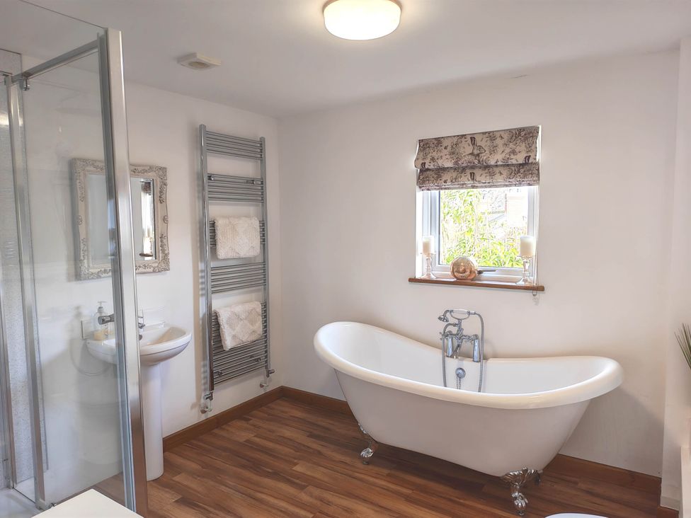 A bathroom featuring a bathtub, shower, and sink at Willow Lodge in Constantine