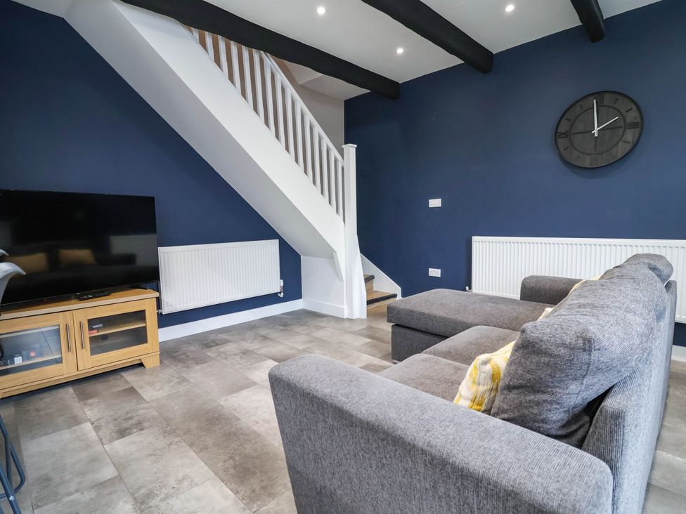 A living room with a sofa and television at 2 Makant Street in Bolton