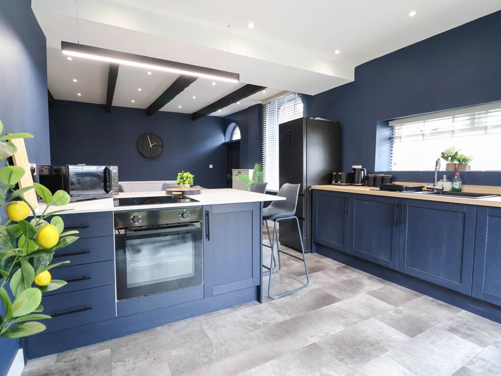 A kitchen with appliances and cabinets at 2 Makant Street Bolton