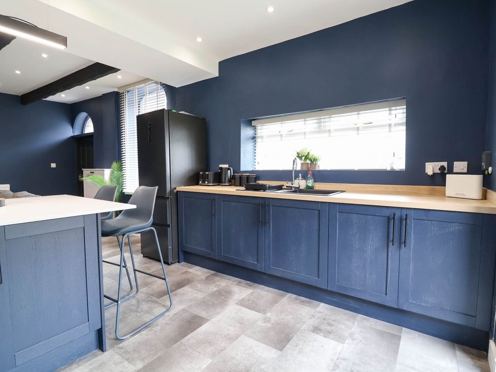 A kitchen with cabinets and a refrigerator at 2 Makant Street Bolton