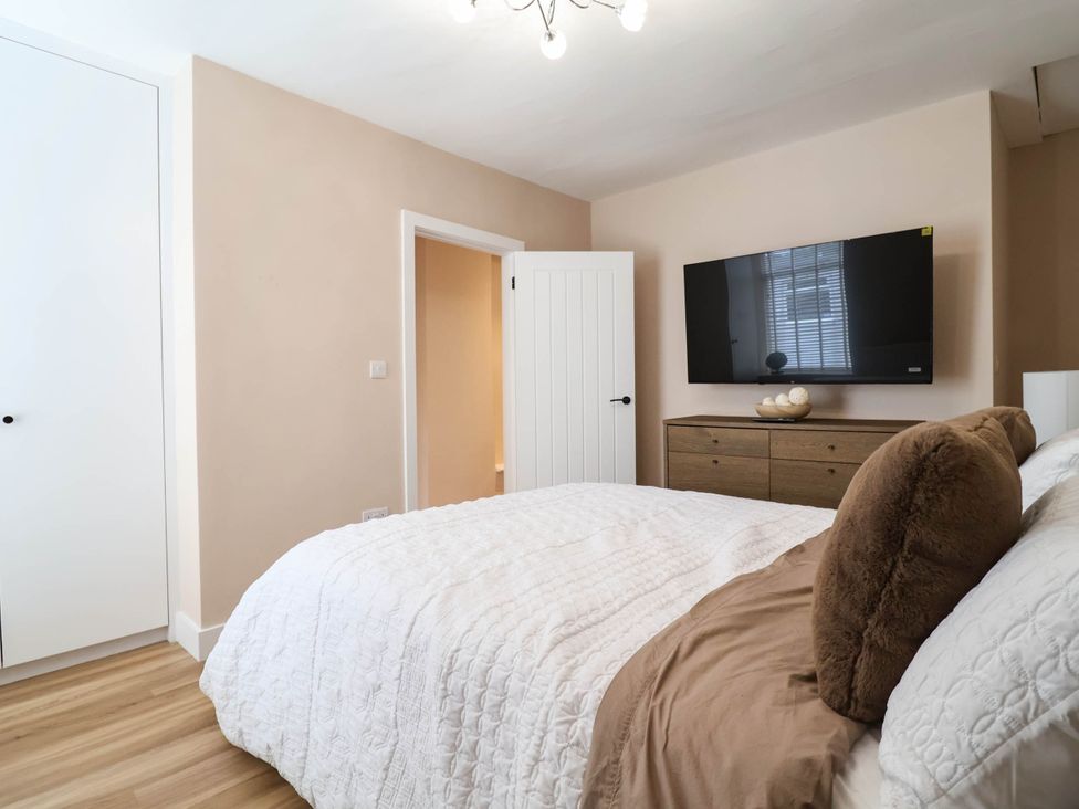 A bedroom with a bed and television at 2 Makant Street Bolton