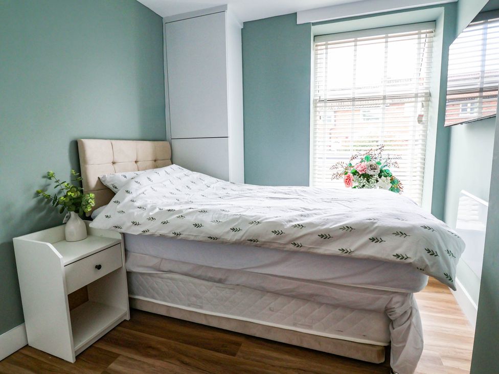 A bedroom with a bed and nightstand at 2 Makant Street in Bolton