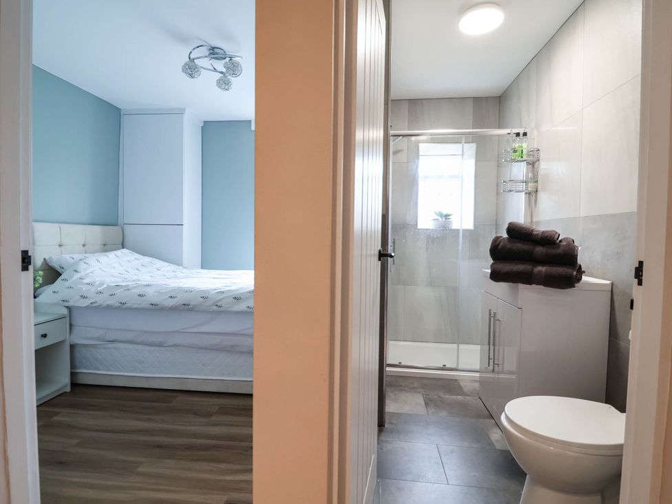 A bathroom with a shower and toilet at 2 Makant Street in Bolton