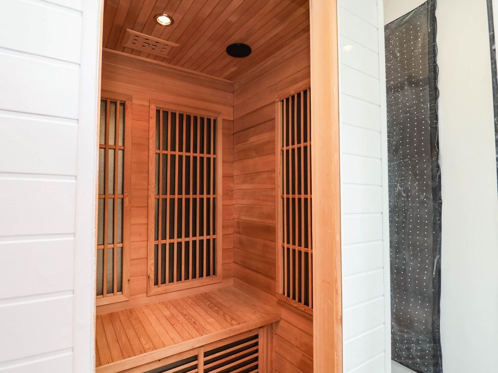 A sauna with wooden bench and paneling at 2 Makant Street in Bolton