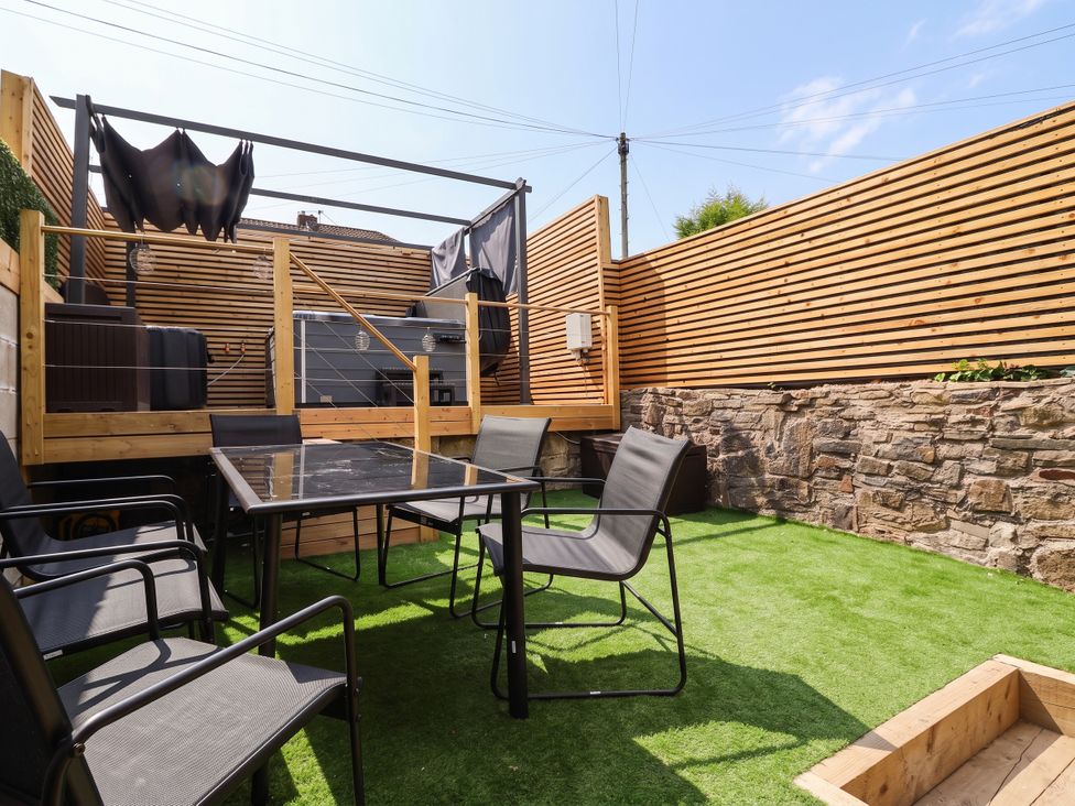 A garden with a table and chairs at 2 Makant Street Bolton