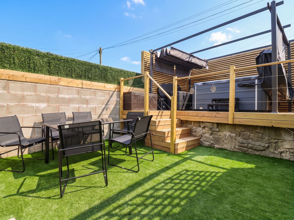 A garden with seating and steps at 2 Makant Street in Bolton