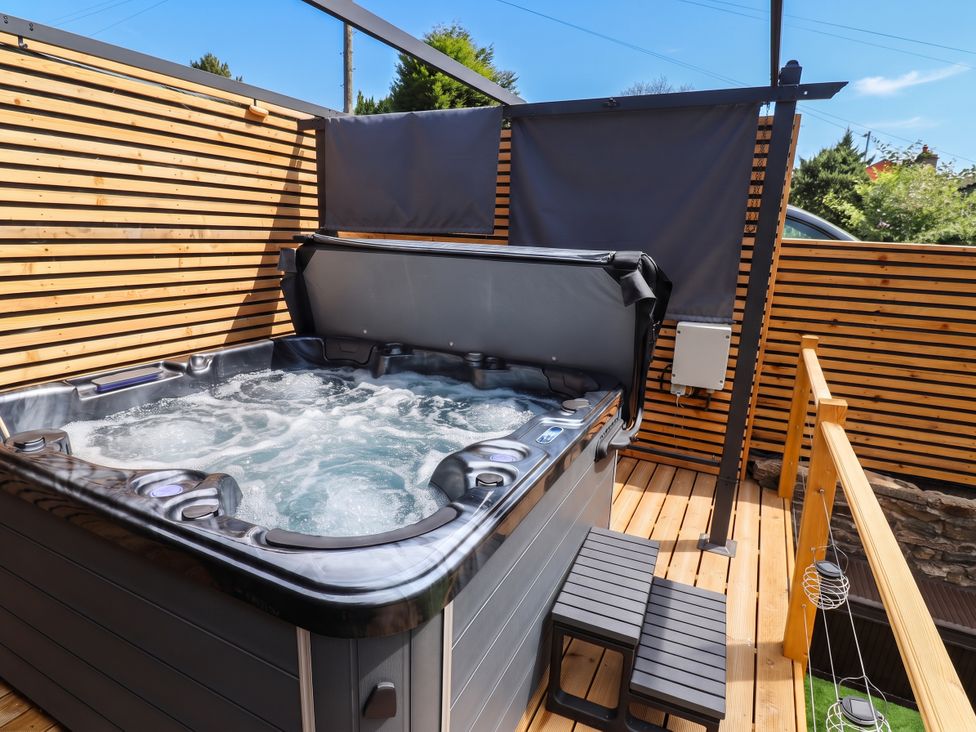 A hot tub on a wooden deck at 2 Makant Street in Bolton