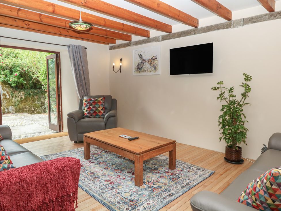 A living room with a sofa and coffee table at Brimble Cottage at Dockwell Farm in Newton Abbot