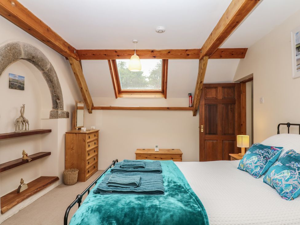 A bedroom with a bed and dresser at Brimble Cottage at Dockwell Farm Newton Abbot