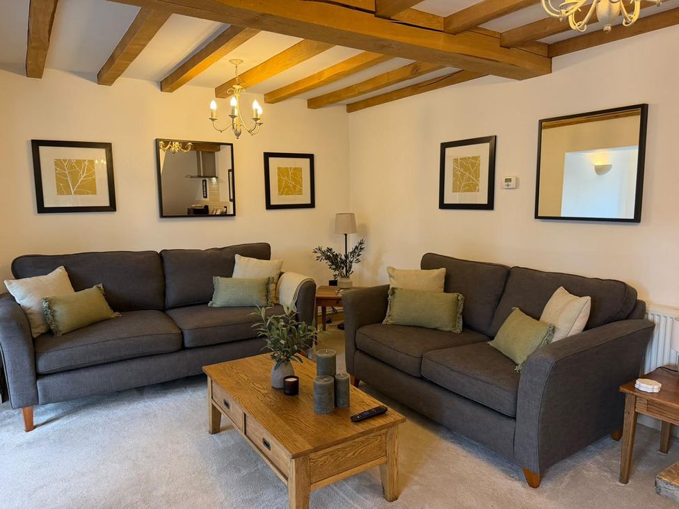 A living room with sofas and a coffee table at Honey Pot Cottage near Harrogate