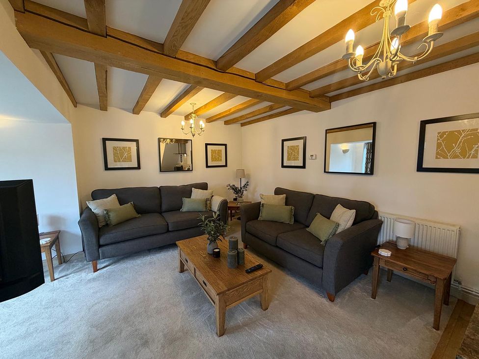 A living room with sofas and a coffee table at Honey Pot Cottage near Harrogate
