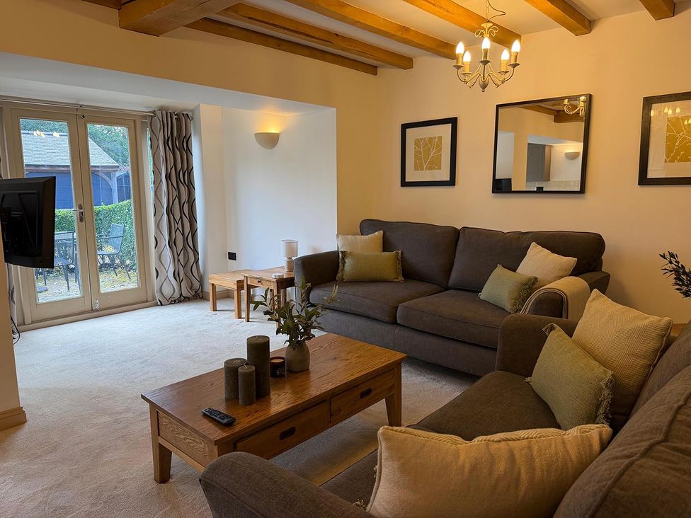 A living room with a sofa and coffee table at Honey Pot Cottage near Harrogate