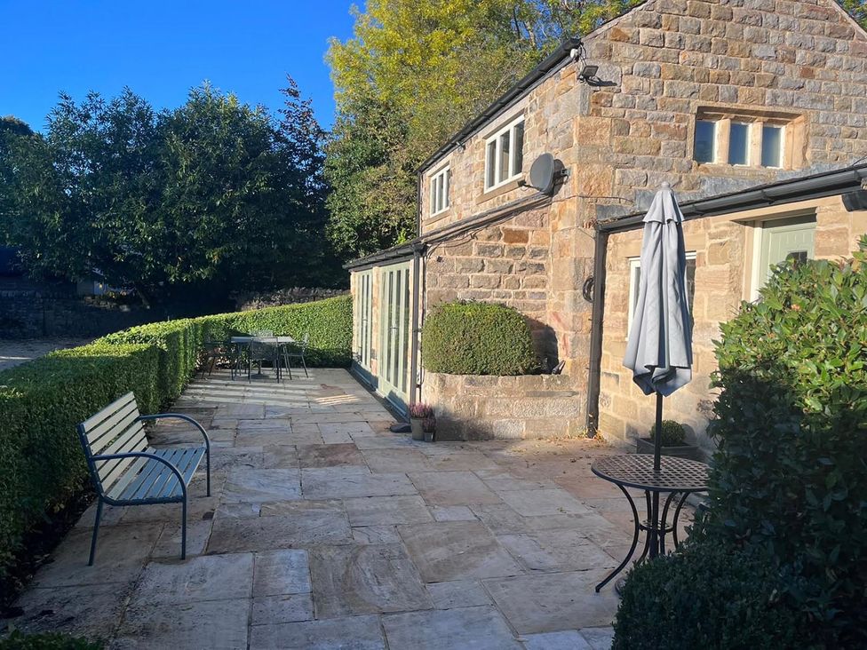 A patio area with a table and chairs at Honey Pot Cottage near Harrogate