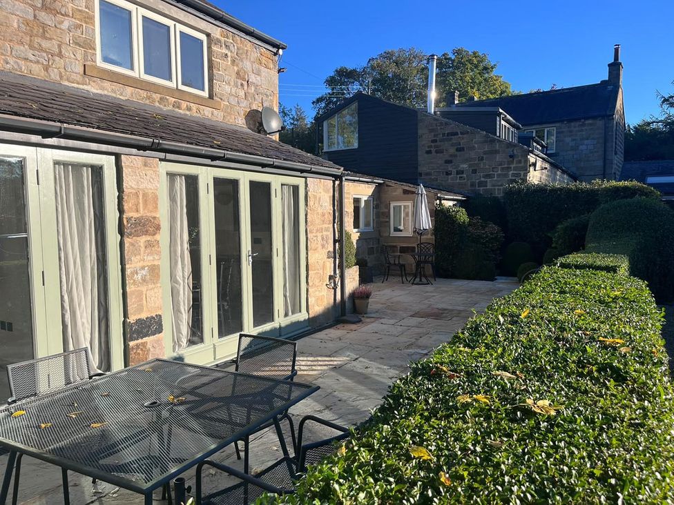 A patio area with a table and chairs at Honey Pot Cottage near Harrogate