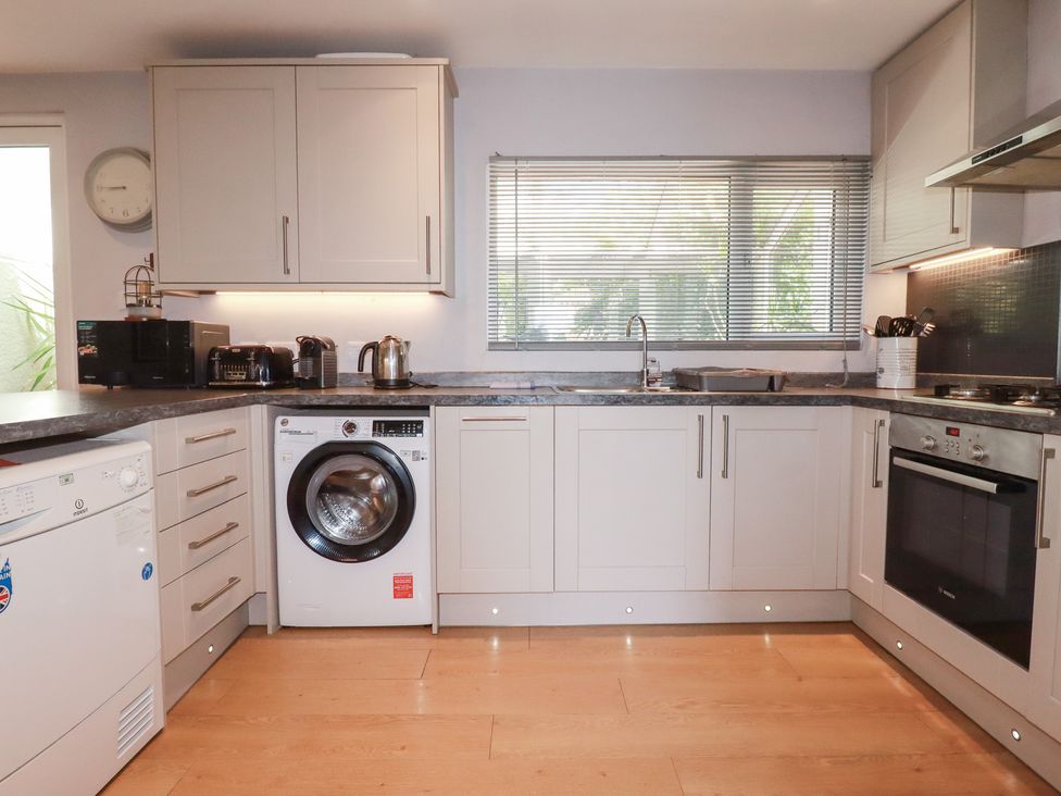 A kitchen with appliances and cabinets at 1 Grenville Road in Truro