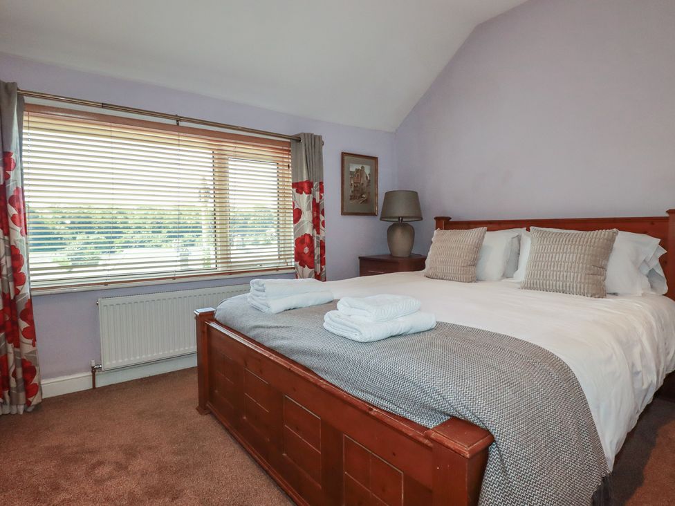 A bedroom with a large bed and a window at 1 Grenville Road Truro