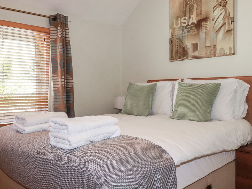 A bedroom with a bed and a window at 1 Grenville Road in Truro
