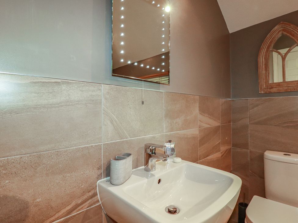 A bathroom with a sink and toilet at 1 Grenville Road in Truro