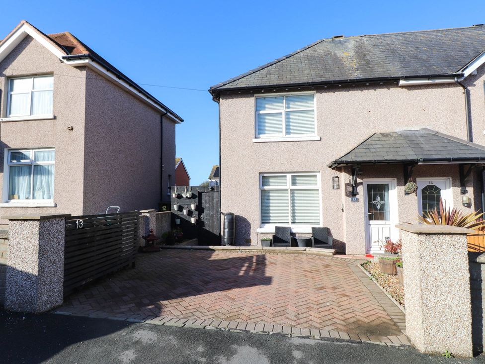 A residential building with a driveway and seating area at Carol Ann Llandudno