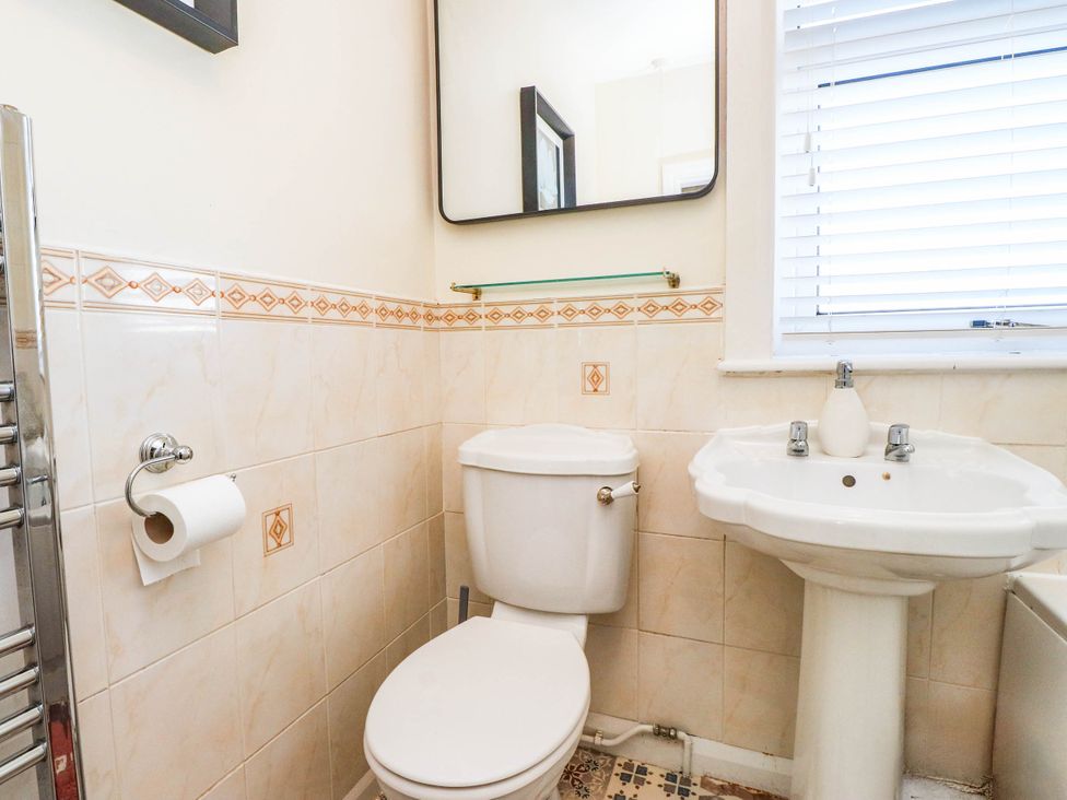 A bathroom with toilet and sink at Carol Ann Llandudno