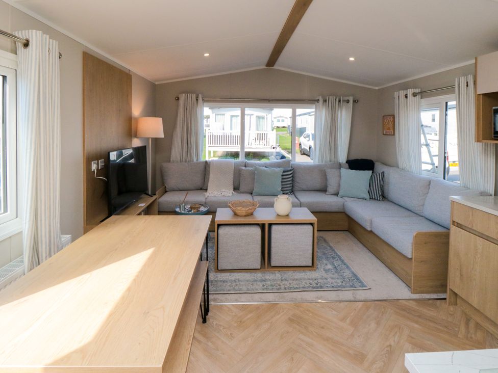 A living room with a sofa and coffee table at 5 Rowen Court in Scarborough