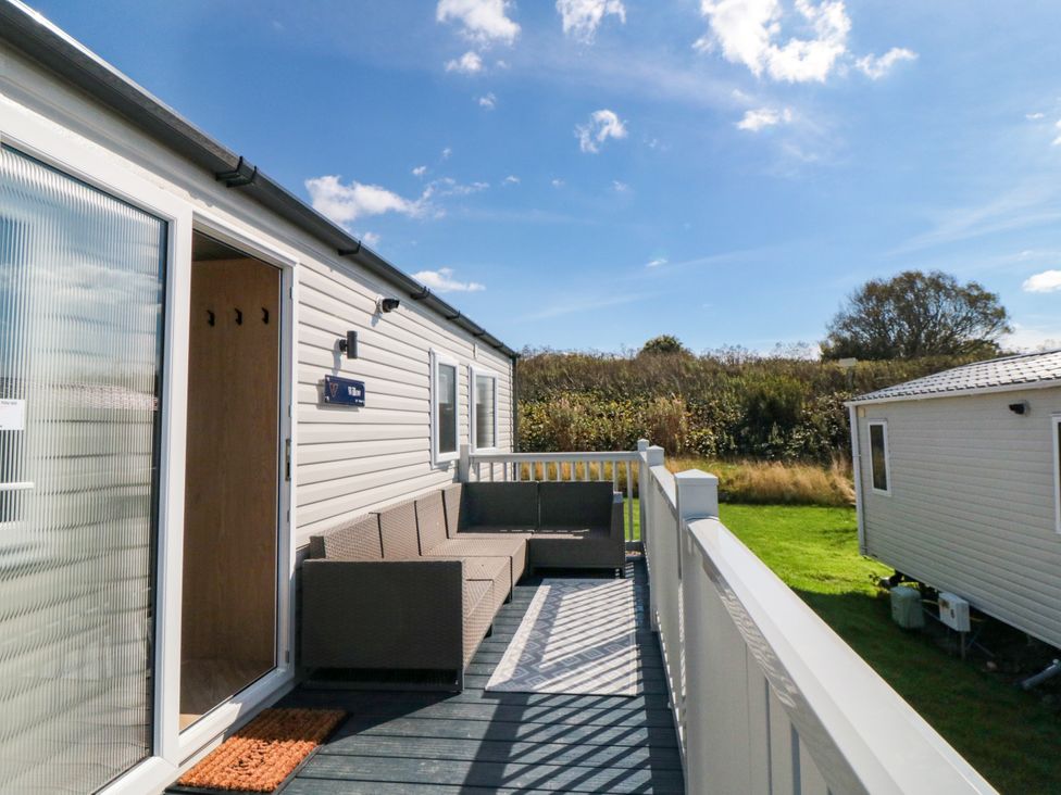 A deck with a sofa and sign at 5 Rowen Court in Scarborough