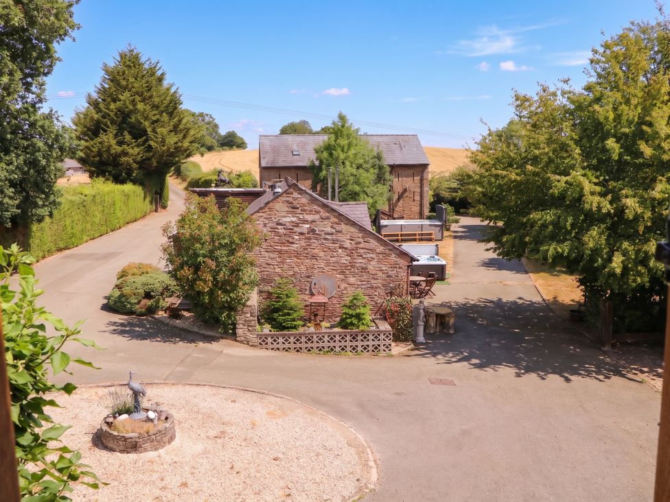 A view of buildings and trees from an outdoor location at The Warm Hearth in Hereford