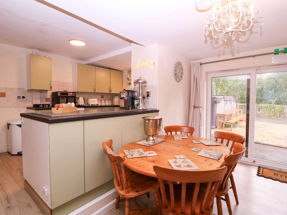 A kitchen with a round table and chairs at The Warm Hearth in Hereford