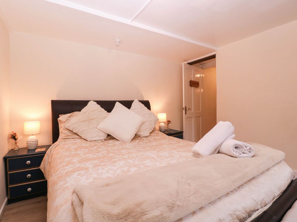 A bedroom with a bed and side tables at The Warm Hearth in Hereford