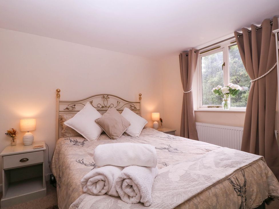 A bedroom with a bed and bedside table at The Warm Hearth in Hereford