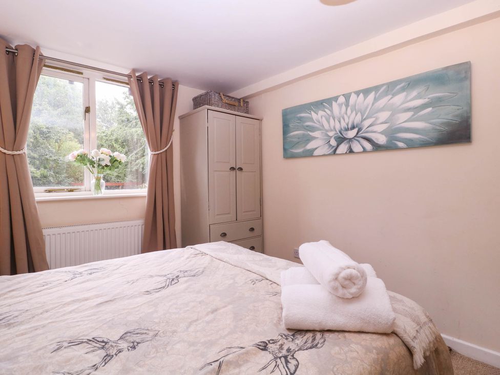 A bedroom with a bed and curtains at The Warm Hearth in Hereford