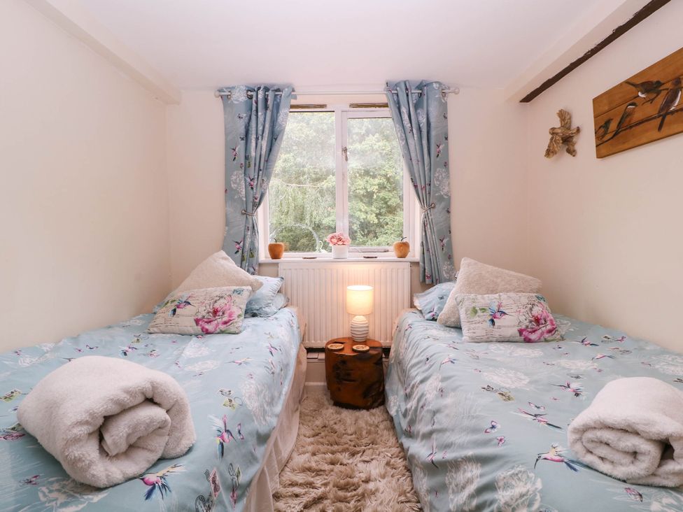 A bedroom with two single beds and a window at The Warm Hearth in Hereford