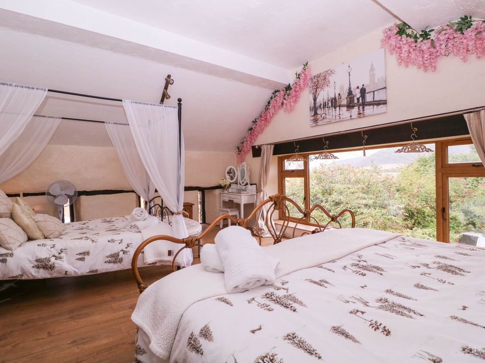 A bedroom with two beds and a window at The Warm Hearth in Hereford