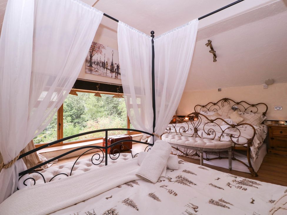 A bedroom with two beds and a large window at The Warm Hearth in Hereford