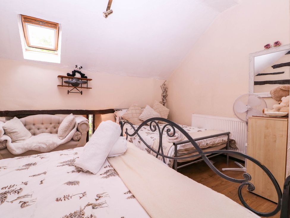 A bedroom with a bed and a fan at The Warm Hearth in Hereford