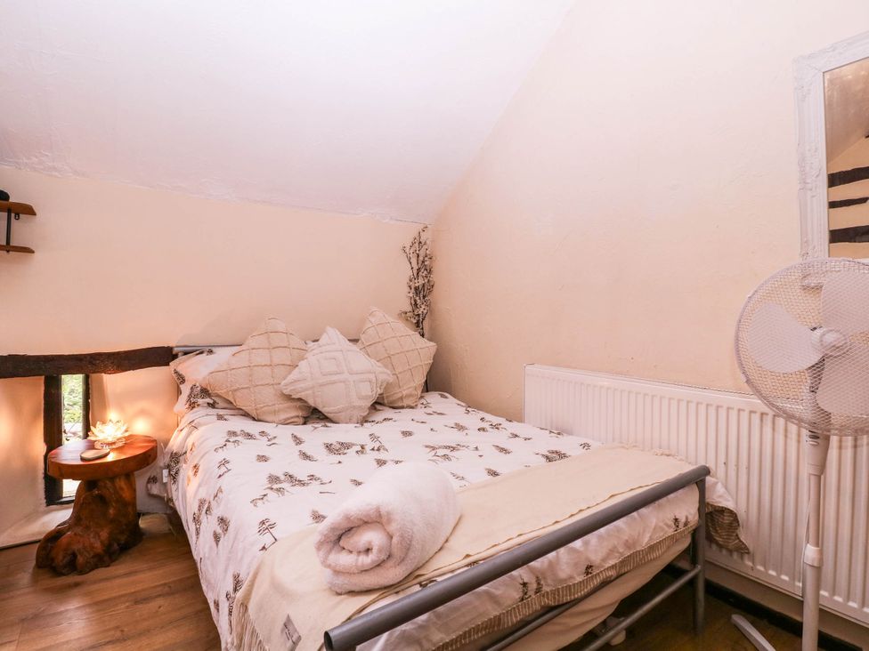 A bedroom with a bed and a small table at The Warm Hearth in Hereford