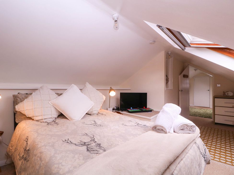 A bedroom with a bed and television at The Warm Hearth in Hereford