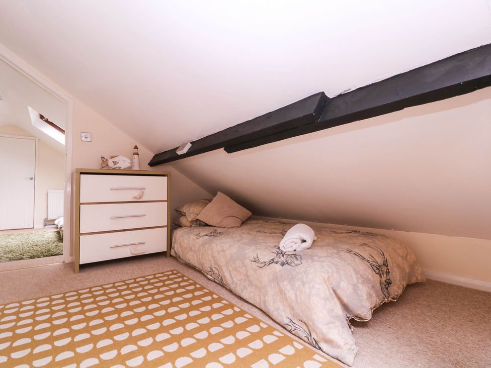 A bedroom with a bed and dresser at The Warm Hearth in Hereford