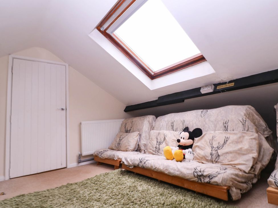 An attic with a sofa and a skylight at The Warm Hearth in Hereford