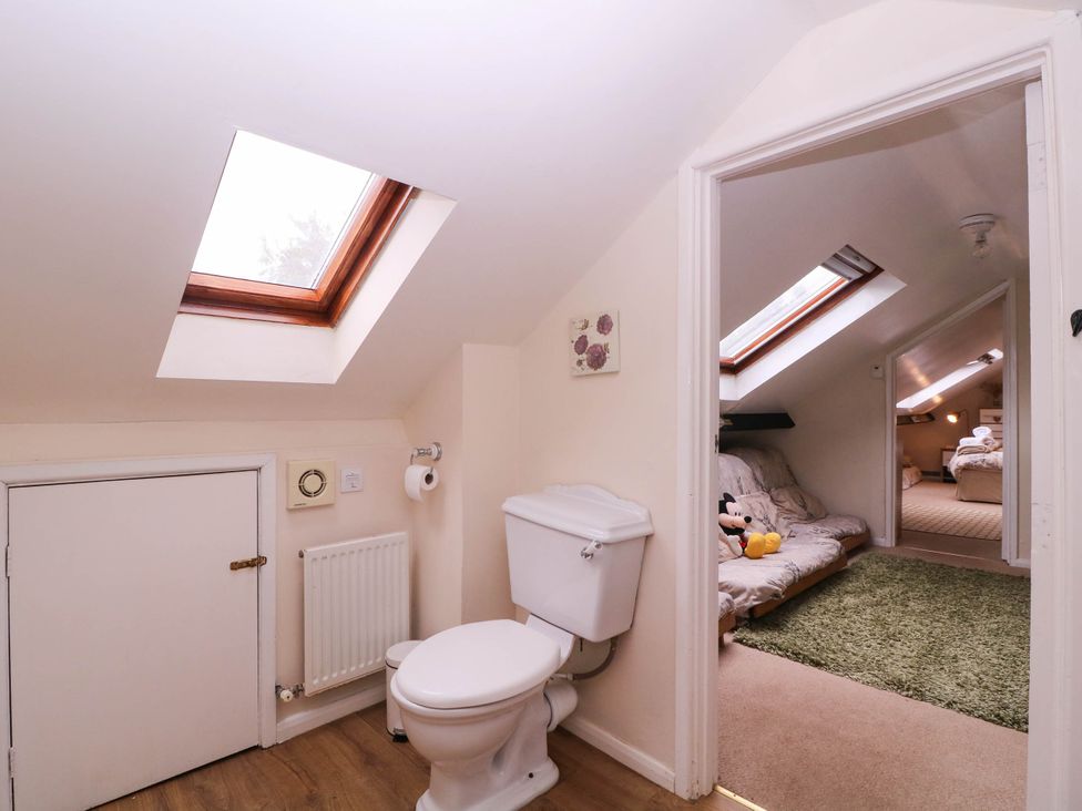 A bathroom with a toilet and a skylight at The Warm Hearth in Hereford