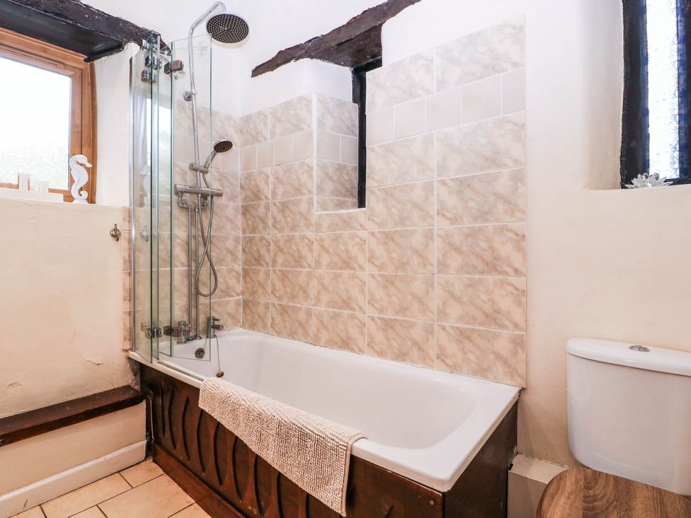 A bathroom with a bathtub and shower at The Warm Hearth in Hereford