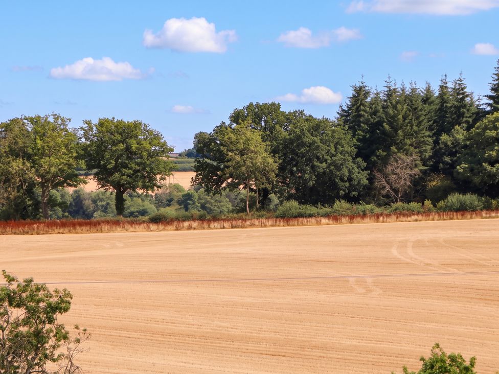 A landscape with fields and trees at The Warm Hearth Hereford