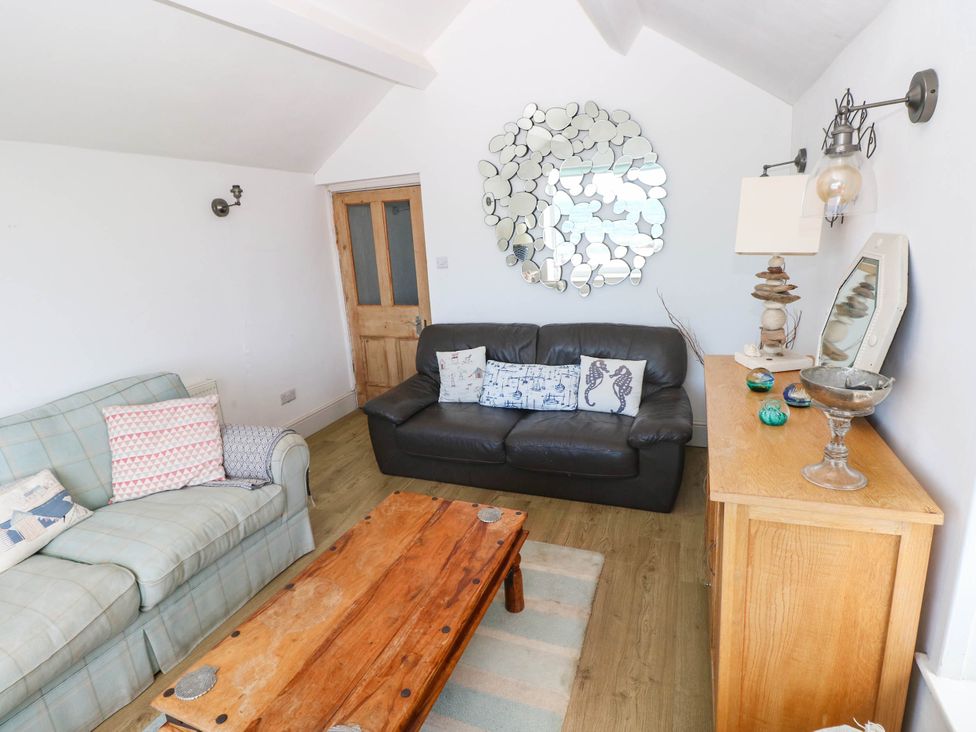 A living room with a sofa and coffee table at Y Glyn in Borth