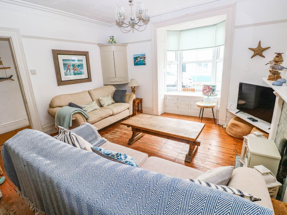 A living room with a sofa and coffee table at Y Glyn in Borth