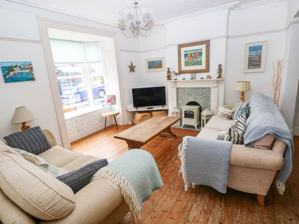 A living room with a television and coffee table at Y Glyn in Borth